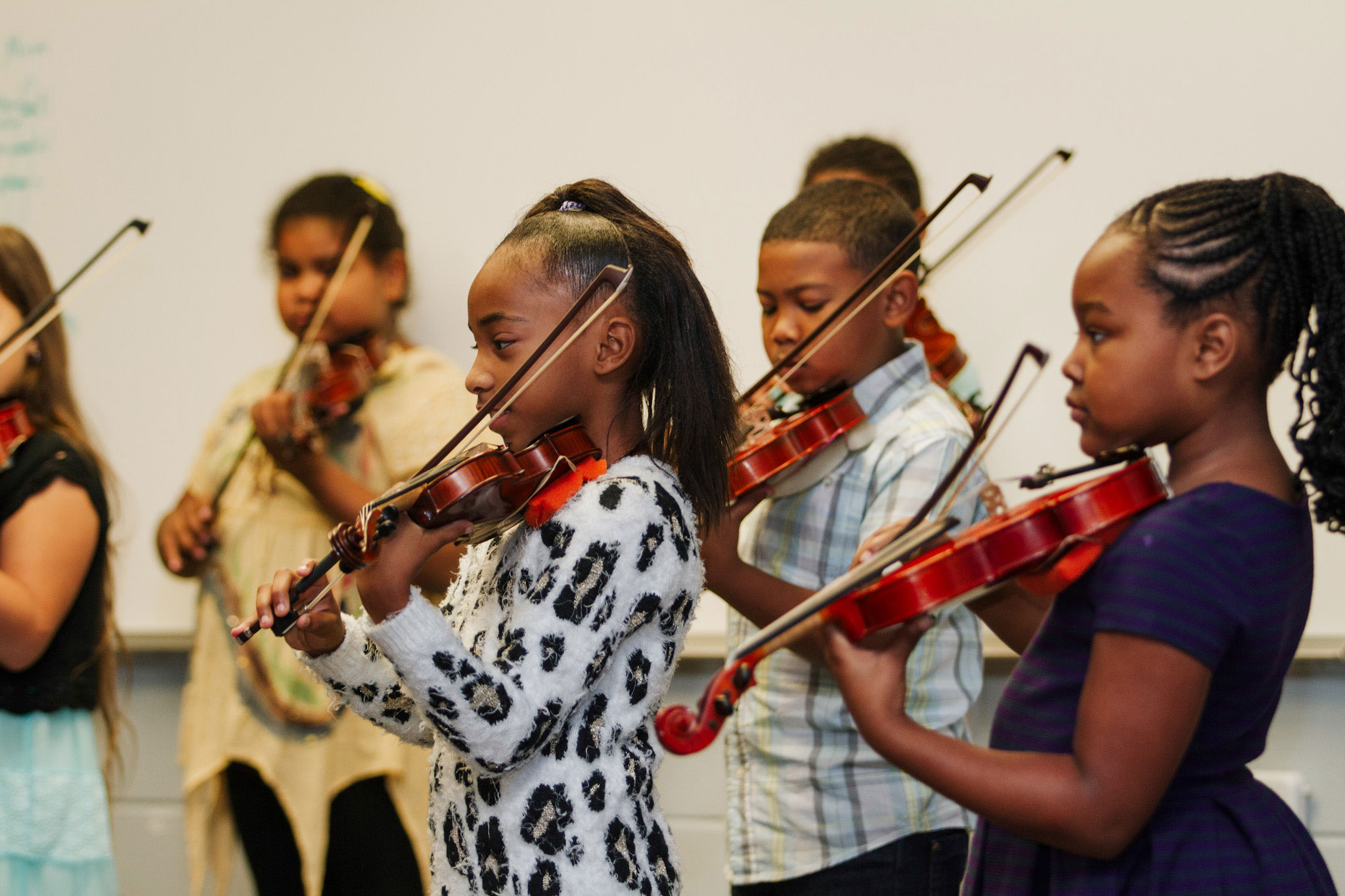 Violin Summer Camp for young students; Children playing violin. 